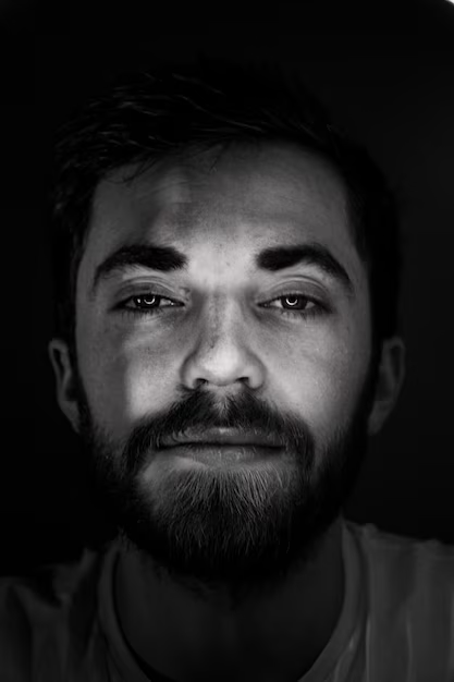 A man posing for his creative black and white headshot in a quirky manner