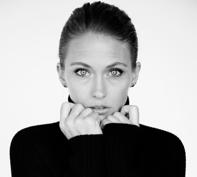 A woman with simple makeup posing for her black and white professional headshot