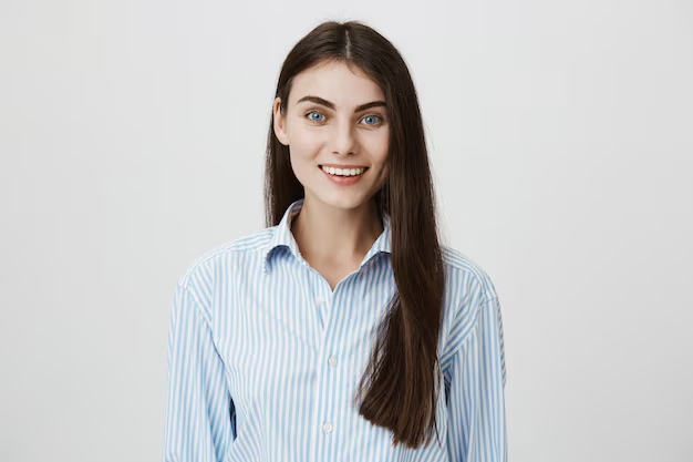 A professional headshot of a girl posing against a white backdrop