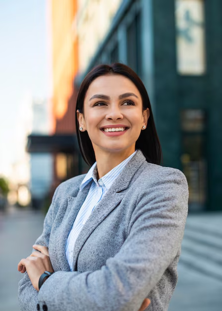 A woman posing for business headshot in an outdoor setting