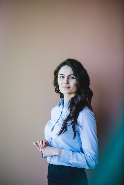 A woman posing for her modern professional headshot against a blurred backdrop