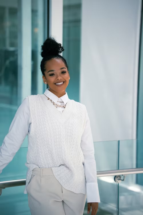 A Professional Headshot example of a woman posing with a welcoming smile on her face.