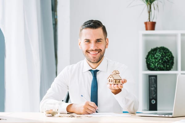 Man posing for a professional headshot in a clear minimal background