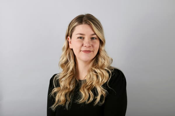 Front profile headshot of a woman in black top